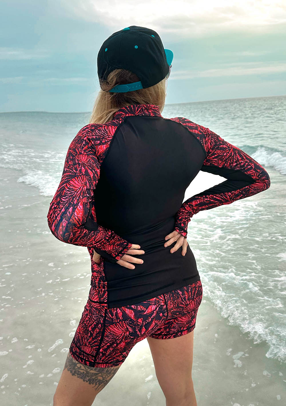 Girl in beach with Lionfish Invasion Rashguard